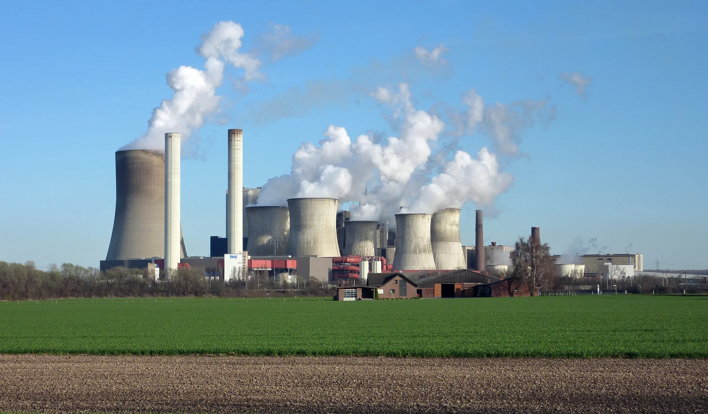 Cooling towers and smokestacks at the Niederaußem lignite coal-fired power station in Germany belching thick plumes of emissions into the sky