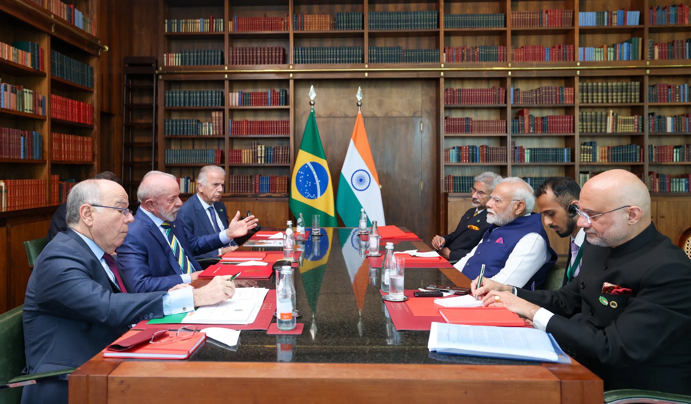 Prime Minister Narendra Modi, External Affairs Minister S. Jaishankar, and the Indian delegation seated across a conference table from President Luiz Inácio Lula da Silva and the Brazilian delegation in Brasília