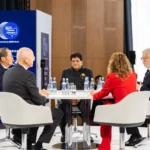 Piyush Goyal, India's Union Minister of Commerce and Industry, smiling at the circular panel table alongside international panellists at the Berlin Global Dialogue 2026
