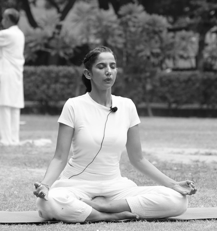 Sapanpreet Grewal meditating outdoors in lotus pose with eyes closed, black and white photograph